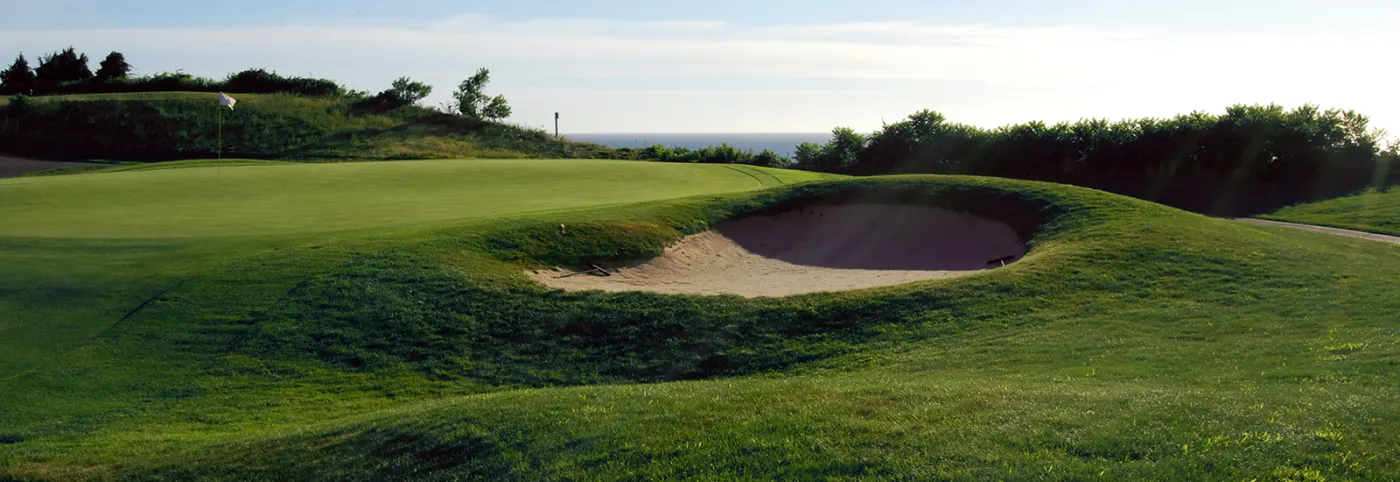 Greenside bunker with the bay on the horizon
